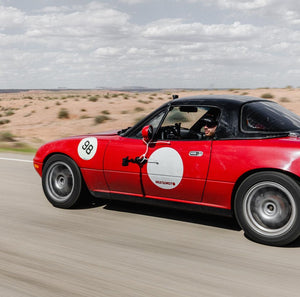 1995 Mazda Miata NA with pop-up headlights, representing the first generation of the iconic roadster.
