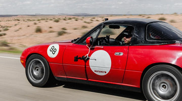 1995 Mazda Miata NA with pop-up headlights, representing the first generation of the iconic roadster.